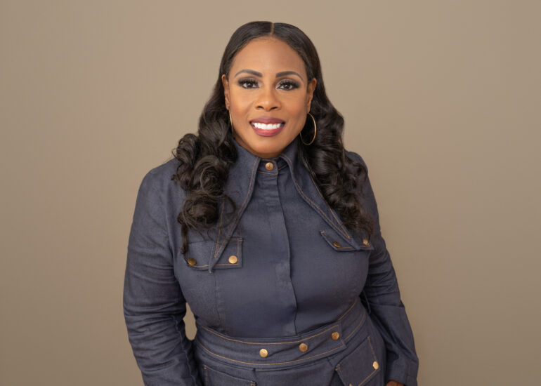 A confident woman smiling during a professional portrait session with Shannon B Whittington Photography, showcasing her natural beauty and strength.